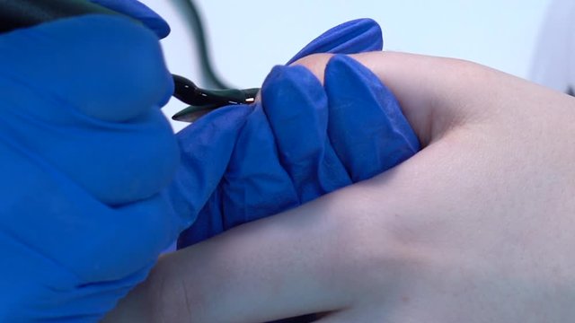 Closeup view 4k video of professional colorful glossy brilliant holiday manicure at fingers of young woman. Modern trendy shiny amazing cat eye effect nail design on black gelpolish.