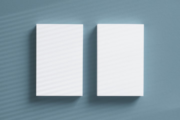 Top view 2 of blank vertical business card stacks with window overlay shadow on grey textured background as template for design presentation, branding promotion etc.