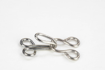 Close up macro of a dress making hook and eye isolated on a white background