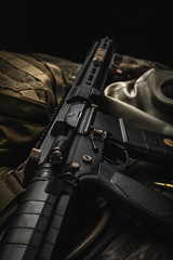 Modern carbine, backpack and gas mask on a wooden back. A set of fighter ready for any battle...