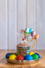 Easter eggs and Easter cake on a wooden table
