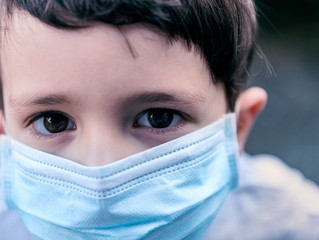 Caucasian boy wearing cloth face mask against coronavirus pandemic