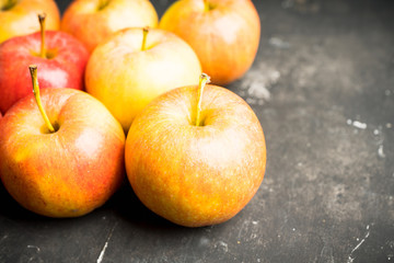 Freshly harvested ripe apple on the rustic wooden background. Selective focus. Shallow depth of field.