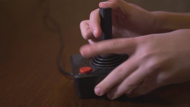 Playing With Old TV Video Game Joystick. The Child Plays With The Help Of His Father