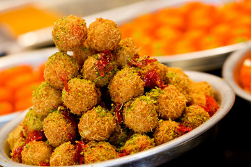 A slice piece of Esmalliyeh Ramadan Arabic sweet pastries & dessert with creamy & pistachio