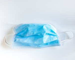 surgical face mask with rubber ear straps for protection against germs on white background