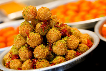 A slice piece of Esmalliyeh Ramadan Arabic sweet pastries & dessert with creamy & pistachio