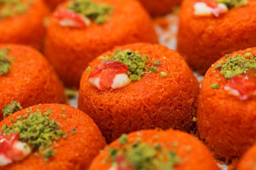 A slice piece of Esmalliyeh Arabic sweets & Ramadan dessert in a white sweet cream