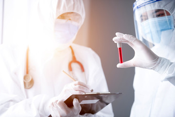 The medical team wore white and blue robes, carrying blood samples in their hands.
