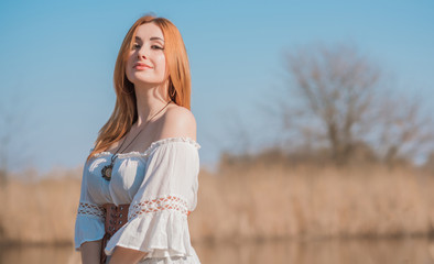 Nature look, Medieval style of clothes, redhead woman in cotton vintage blouse, belt and skirt