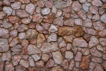 Texture of stone wall made of grey stones