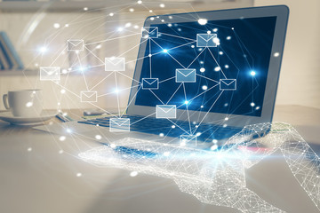 Desktop computer background in office and flying envelops hologram drawing. Multi exposure. Electronic mail concept.