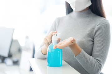 Woman wearing face mask protective for spreading of disease virus SARS-CoV-2 and hand wash cleaning...