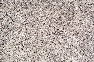 Texture of the old wall of an old gray house. Texture with cracks in the wall.