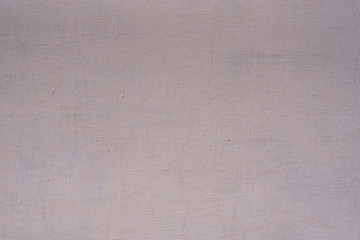 Texture of the old wall of an old gray house. Texture with cracks in the wall.
