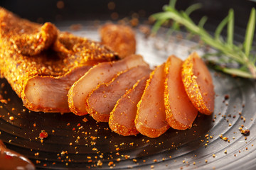 Seasoned chicken with hot sauce and a sprig of rosemary