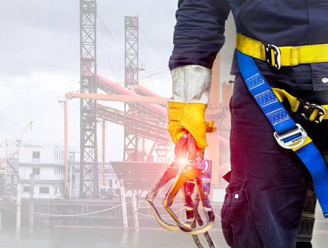 Close-up harnesses and gloves, Working at height equipment. Fall arrestor device for worker with double hooks for safety body harness on selective focus, Safety background and  beautiful