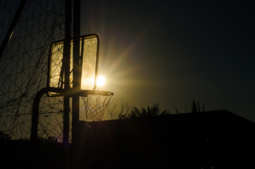 Fototapeta na wymiar basketball hoop at sunset