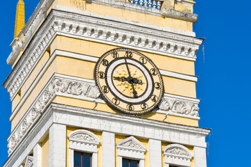 beautiful clock on a beautiful colorful building side view