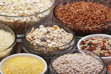 A set of bowls filled with different seeds: buckwheat, rise, corn and oatmeal	