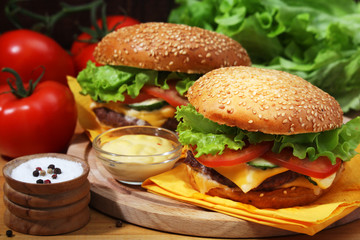 Two fresh hamburgers with vegetables	