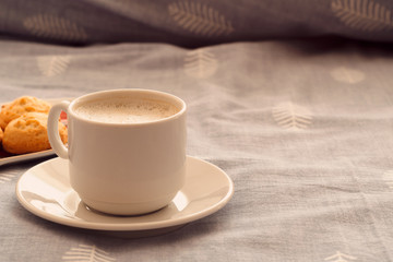 morning breakfast in bed. a cup of strong coffee and cookies on the bed. romantic breakfast with your beloved