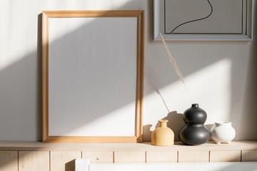 Photo frame mockup and ceramic vases. Scandinavian interior.