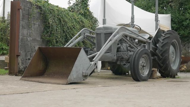 A Small Bulldozer Parked On The Corner  Used To Prepare For the Wedding. -medium shot