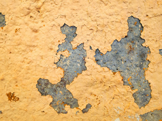 Concrete is puttied and painted with yellow paint. Retro ruined wall, exposure to moisture and damp.An example of a lack of maintenance and repair.Peeling plaster. For advertising funds from corrosion
