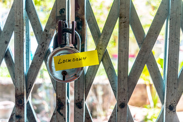 Lockdown sticker on door lock gate. Stay at home saying during self-quarantine and Lockdown at...