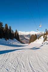 View of an alpine ski slope with cable car lift