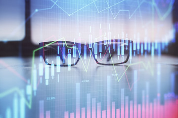 Financial graph hologram with glasses on the table background. Concept of business. Double exposure.