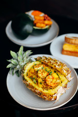 Pineapple fried rice served in a pineapple shell container, eco-friendly food packaging