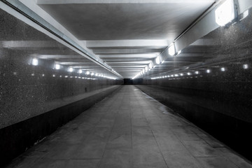 Underground pedestrian crossing. A long concrete tunnel in the city underground. Underpass....