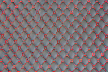Close up leather texture with red rhombus seam