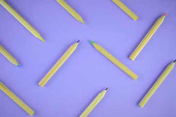 
Multi-colored pencils scattered on the background