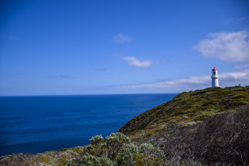 Fototapeta na wymiar The lighthouse near the coast of the sea with clear blue sky background in Australia