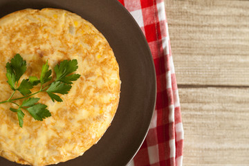 Spanish omelette in a plate with napkin