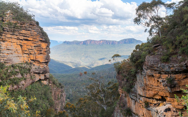 Panoramic Blue Mountains Australia. Dramatic views of peaks, rock, valley, landscape, green rainforest jungle. Adventure, freedom, fun concepts. Tourist mountain trek. Shot in Sydney, NSW.