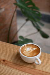 coffee latte art on wooden table in a cafe