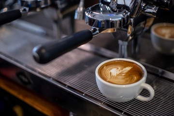 coffee latte on espresso machine in coffee shop 