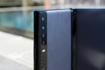 New folding phone of the swimming pool background