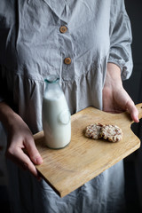 almond vegetarian milk and gluten-free cookies in woman hand