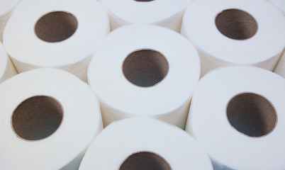 A lot of white toilet paper rolls side by side close to each other. Do not panic. Do not worry.