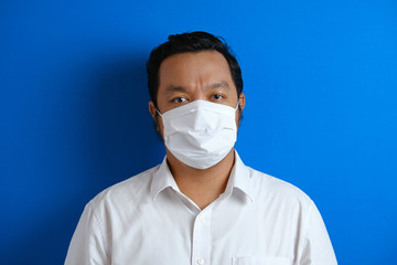 a fat Asian man wearing a mask