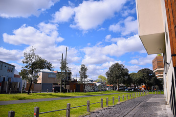 The houses with green grass field and cloudy blue sky background on sunny day in Melbourne, Australia