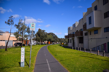 The houses with green grass field and cloudy blue sky background on sunny day in Melbourne, Australia