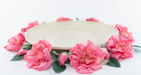 Wooden dish. The plate is decorated with flowers. Festive decoration.
