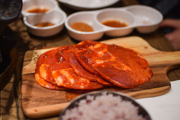 The raw meat with spices on the wooden plate in the restaurant in Melbourne, Australia