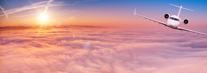 Fototapeta na wymiar Small private jetplane flying above beautiful clouds. Travel and transportation concept.
